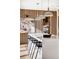 Contemporary kitchen island with white countertop and black barstools at 2471 Quitman St, Denver, CO 80212