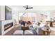 Sunlit living room with a modern fireplace, hardwood floors, large windows, and stylish decor at 2471 Quitman St, Denver, CO 80212