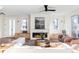 Modern living room with a linear fireplace, white tile surround, and built-in benches at 2471 Quitman St, Denver, CO 80212