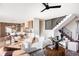 Bright, open-concept living room with modern furnishings, a staircase and adjacent eat-in kitchen area at 2471 Quitman St, Denver, CO 80212