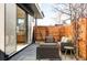 Private patio with modern furniture and sliding glass doors to interior at 2471 Quitman St, Denver, CO 80212