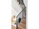 Modern staircase with wood steps and black metal railing at 2471 Quitman St, Denver, CO 80212