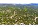 Picturesque community featuring homes nestled among lush trees, offering a tranquil setting near a well-maintained golf course at 2907 Hiwan Dr, Evergreen, CO 80439
