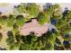 Expansive home with a brown roof is surrounded by dense, mature trees creating a private and secluded atmosphere at 2907 Hiwan Dr, Evergreen, CO 80439