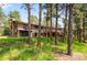 Scenic exterior view of a two-story home with multiple decks surrounded by trees at 2907 Hiwan Dr, Evergreen, CO 80439