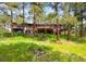 Exterior view of a home with a spacious deck and lush green lawn at 2907 Hiwan Dr, Evergreen, CO 80439