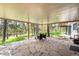 Covered back patio with stone flooring and a view of the wooded surroundings at 2907 Hiwan Dr, Evergreen, CO 80439
