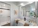Well-lit bathroom featuring double sinks, spacious shower, and tasteful decor at 2907 Hiwan Dr, Evergreen, CO 80439