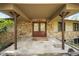 Covered front entrance with a stone facade, double doors, and decorative lighting at 2907 Hiwan Dr, Evergreen, CO 80439