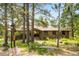 Charming single-story home with stone accents, mature trees, and inviting curb appeal at 2907 Hiwan Dr, Evergreen, CO 80439