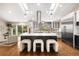 Contemporary kitchen featuring a large island, modern stools, and stainless steel appliances at 2907 Hiwan Dr, Evergreen, CO 80439
