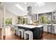 Bright kitchen with a large island, modern stools, stainless steel appliances, and an open layout at 2907 Hiwan Dr, Evergreen, CO 80439