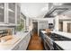 Modern kitchen featuring stainless steel appliances, sleek white countertops, and an expansive view of the outdoors at 2907 Hiwan Dr, Evergreen, CO 80439