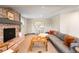 Inviting living room boasts a brick fireplace and comfortable gray sectional sofa at 2907 Hiwan Dr, Evergreen, CO 80439