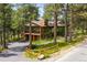 Beautiful two-story home with a large upper deck and an attached garage, set in mature trees at 2907 Hiwan Dr, Evergreen, CO 80439