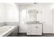 Bathroom featuring a soaking tub, modern fixtures, and a bright vanity area at 2540 S Monroe St, Denver, CO 80210