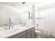 Well-lit bathroom with double sink vanity, tub/shower combo with modern fixtures at 2540 S Monroe St, Denver, CO 80210