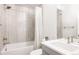 Modern bathroom with tiled shower, bathtub, and a sleek vanity with stylish fixtures at 2540 S Monroe St, Denver, CO 80210