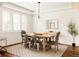 Bright dining room showcases hardwood floors, a modern light fixture, neutral paint, and bright windows at 2540 S Monroe St, Denver, CO 80210