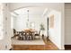 Charming dining room featuring hardwood floors, neutral paint, a modern light fixture, and a bright window at 2540 S Monroe St, Denver, CO 80210