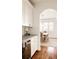 Kitchen featuring a wine cooler and an archway leading to a dining area with natural light at 2540 S Monroe St, Denver, CO 80210