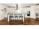 Spacious white kitchen with a large island, stainless steel appliances and elegant pendant lighting at 2540 S Monroe St, Denver, CO 80210