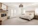 Spacious main bedroom with stone fireplace, tray ceiling and elegant light fixture at 2540 S Monroe St, Denver, CO 80210