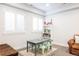 Bright playroom with table and chairs, bookshelf, and large windows at 2540 S Monroe St, Denver, CO 80210