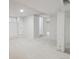 Finished basement area with carpet, white walls, and a visible support beam at 1111 S Corona St, Denver, CO 80210