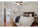 Bright bedroom with hardwood floors, ceiling fan, and cozy furnishings at 1111 S Corona St, Denver, CO 80210