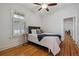 Bedroom featuring hardwood floors, a ceiling fan, and natural light from a window at 1111 S Corona St, Denver, CO 80210