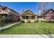 Charming bungalow featuring a brick facade, well-maintained lawn, and inviting front porch at 1111 S Corona St, Denver, CO 80210