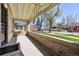 Inviting front porch with brick surround and shade from mature trees at 1111 S Corona St, Denver, CO 80210
