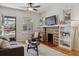 Inviting living room with a brick fireplace, hardwood floors, and a view of the front porch at 1111 S Corona St, Denver, CO 80210