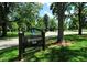 Sign for Washington Park surrounded by mature trees and greenery on a sunny day at 1111 S Corona St, Denver, CO 80210