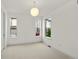 Neutral bedroom boasts three windows, a modern pendant light, and neutral carpet at 9566 Poppy Way, Arvada, CO 80007
