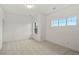Bright bedroom with neutral carpet, white walls, and well-lit by two windows at 9566 Poppy Way, Arvada, CO 80007