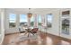 Bright dining area with a modern chandelier, a stylish table set for four, and large windows with neighborhood views at 9566 Poppy Way, Arvada, CO 80007