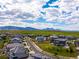 Scenic neighborhood street view showcasing beautiful homes with well-kept lawns and mountain views at 9566 Poppy Way, Arvada, CO 80007