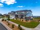 The beautiful home features a three-car garage, a combination of stone and siding, and a well-manicured front yard at 9566 Poppy Way, Arvada, CO 80007