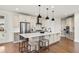 Spacious kitchen island features modern cabinetry, pendant lighting, and stainless steel appliances at 9566 Poppy Way, Arvada, CO 80007