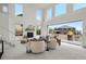 Living room with high ceilings, a fireplace, comfortable seating, and sliding glass doors to the outdoor deck at 9566 Poppy Way, Arvada, CO 80007