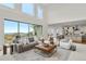 Open-concept living room featuring high ceilings, large windows, and a seamless connection to the kitchen and dining area at 9566 Poppy Way, Arvada, CO 80007