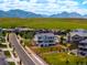 Scenic view of a modern neighborhood with tree-lined streets and distant mountain backdrop at 9566 Poppy Way, Arvada, CO 80007