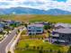 Wide aerial view of a neighborhood showcasing manicured lawns and mountain views at 9566 Poppy Way, Arvada, CO 80007