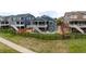 Aerial view of a house with a fenced backyard, fire pit, lush green lawn, and outdoor stairs leading to deck at 11817 Phoebe St, Parker, CO 80134