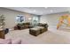 Spacious carpeted basement featuring large sectional couch, windows, and a climbing gym at 11817 Phoebe St, Parker, CO 80134