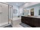 Elegant bathroom with walk-in shower, soaking tub, and dual vanity at 11817 Phoebe St, Parker, CO 80134