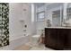 Neat bathroom featuring tiled shower with flower-patterned shower curtain, toilet and vanity at 11817 Phoebe St, Parker, CO 80134