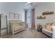 A charming Bedroom bathed in light, featuring a cozy crib, soft textures, and comforting decor at 11817 Phoebe St, Parker, CO 80134